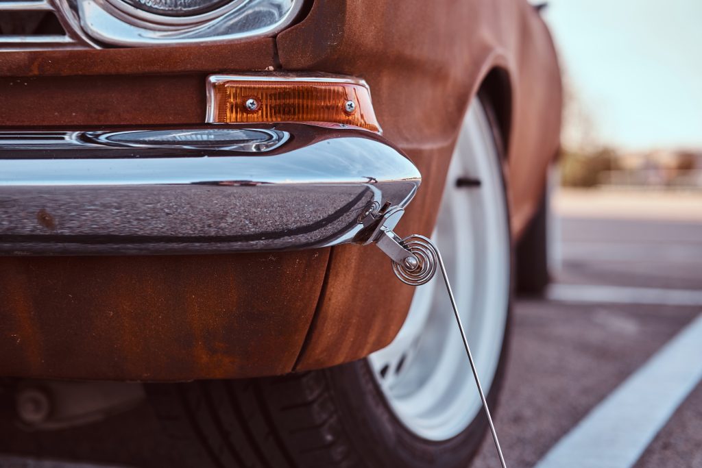 Country style concept. Cropped front view of a restored retro car.