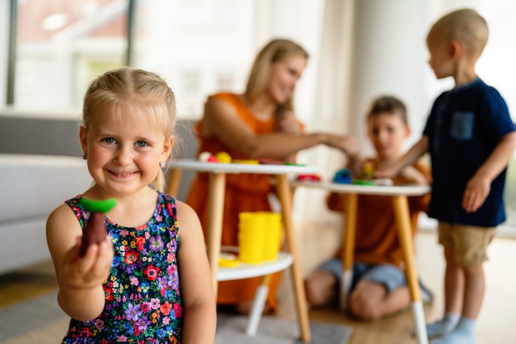 Family activities in the kids room. Woman and children playing together. Fun, education concept.
