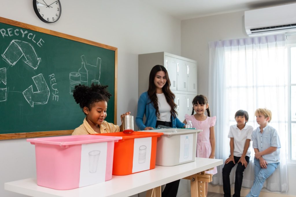 Group of student learn with teacher in classroom at elementary school. Attractive beautiful female instructor master explain and educate young children with happiness and fun activity at kindergarten.