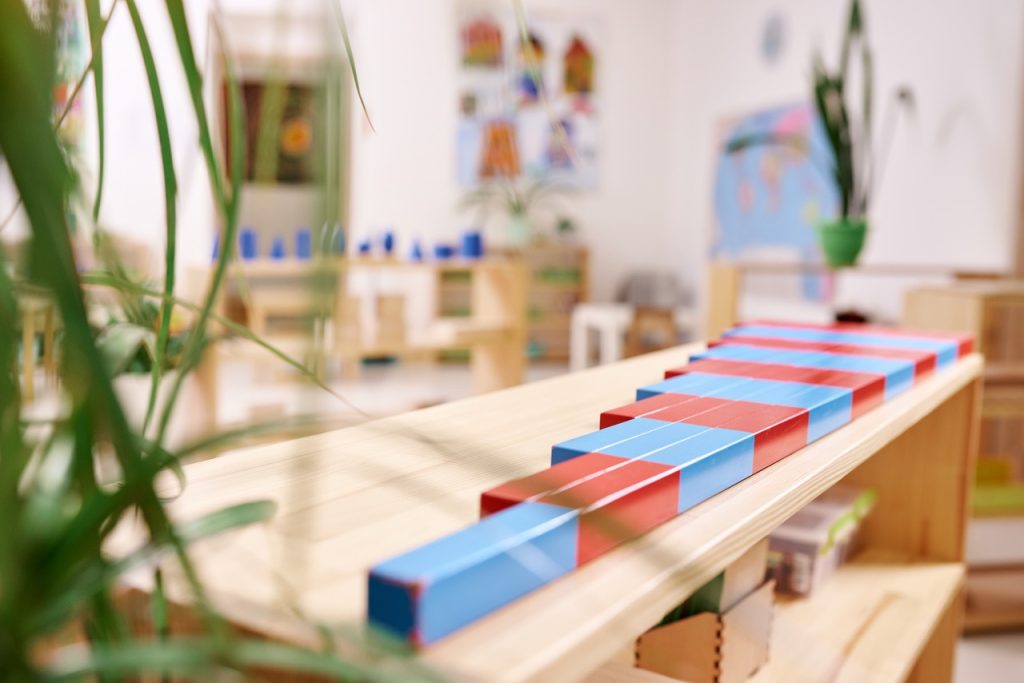 Light class in Montessori kindergarten. The colorful numeric rods in the foreground. nobody.