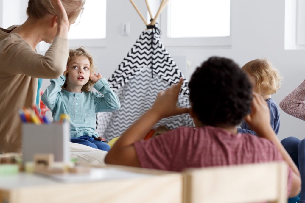 Teacher playing the game with her preschool pupils