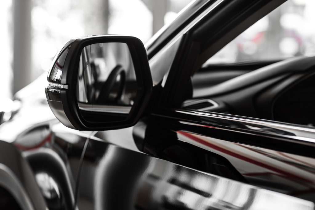 side rear-view mirror on a car. rear view mirror. Focus to mirror view