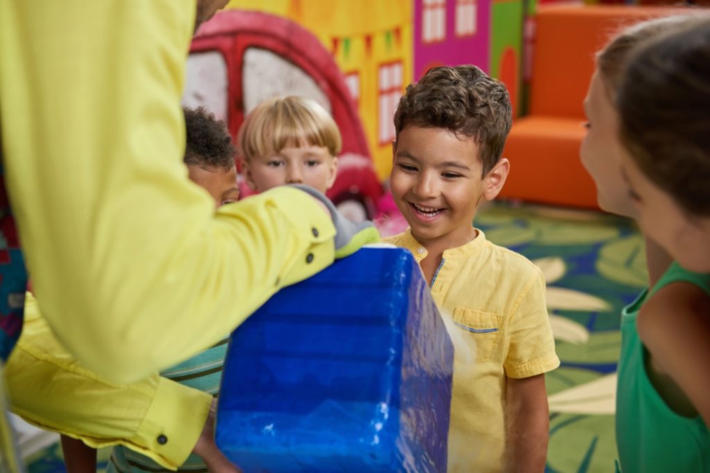 Scientific show for kids. Happy kids having fun in playroom. Positive emotions and facial expressions.