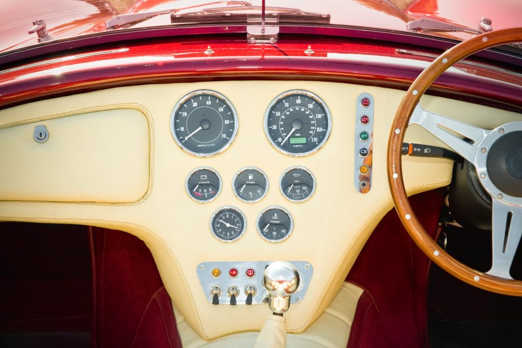 interior and dashboard detail of a restored retro soft-top sports car